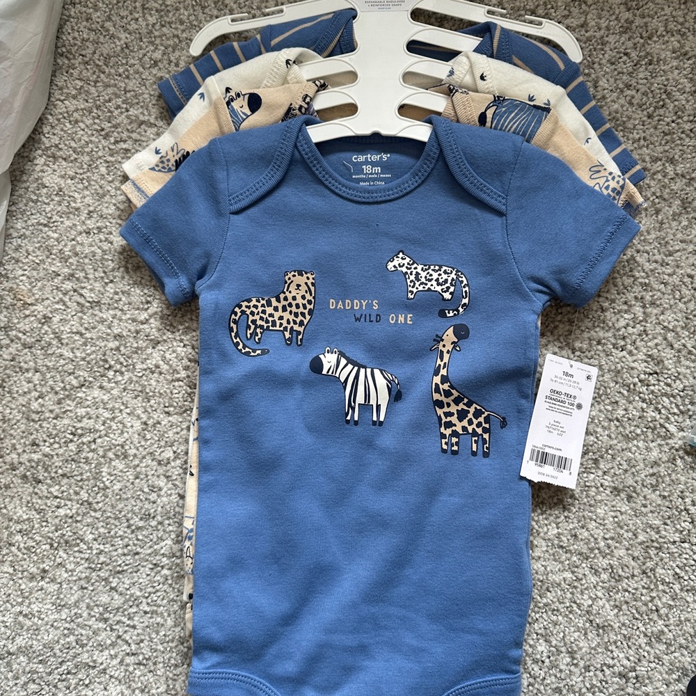 Four Carter’s onesies, new with tags. 18m
